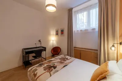 a bedroom with a bed and a desk and a window at Appartamento moderno e silenzioso a Trastevere in Rome