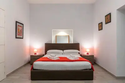 a bedroom with a large bed with two night stands at Loft tra Castel Sant'Angelo e centro storico in Rome