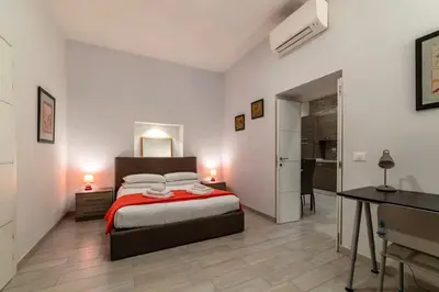 a bedroom with a bed and a desk with two lamps at Loft tra Castel Sant'Angelo e centro storico in Rome