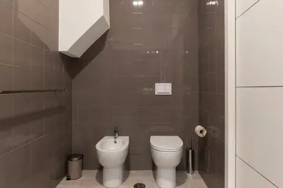 a small bathroom with a toilet and a sink at Loft tra Castel Sant'Angelo e centro storico in Rome