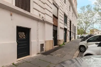 a street with cars parked next to a building with a door at Loft tra Castel Sant'Angelo e centro storico in Rome