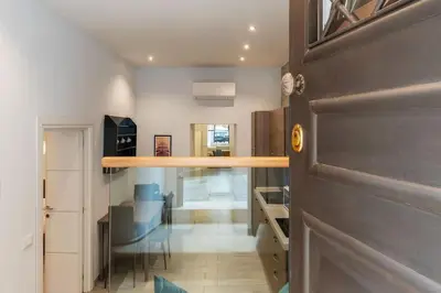 a room with a door and a kitchen with a table at Loft tra Castel Sant'Angelo e centro storico in Rome