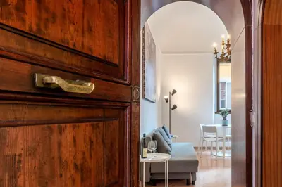 an open door to a living room with a table at Tipico appartamento nel cuore di Trastevere in Rome