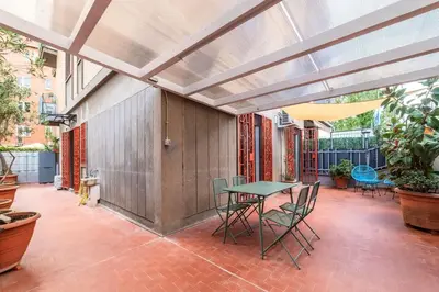 an outdoor patio with a table and chairs at Vivace appartamento con splendido giardino in Rome