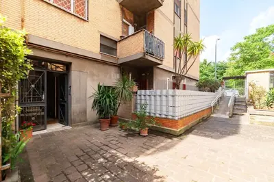 a building with potted plants in front of it at Vivace appartamento con splendido giardino in Rome