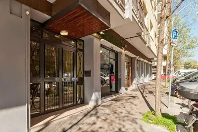 a store front with glass doors on a street at Nuovo e ampio appartamento vicino metropolitana in Rome