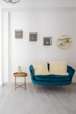 a living room with a blue couch and a table at Appartamento panoramico vicino San Pietro e Vaticano in Rome