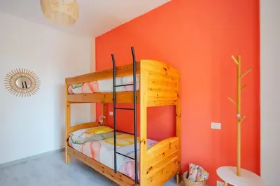 a bunk bed in a room with an orange wall at Appartamento panoramico vicino San Pietro e Vaticano in Rome