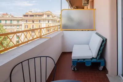 a balcony with a chair and a chalkboard on a building at Appartamento panoramico vicino San Pietro e Vaticano in Rome