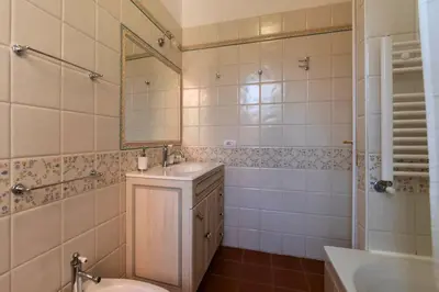 a bathroom with a sink and a toilet and a mirror at Appartamento nel cuore del pittoresco Pigneto in Rome