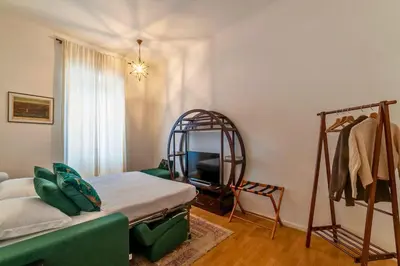 a bedroom with a bed and a mirror and a tv at Appartamento nel cuore del pittoresco Pigneto in Rome