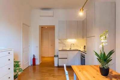 a kitchen with a wooden table with a potted plant at Appartamento nel cuore del pittoresco Pigneto in Rome