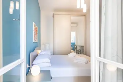 a bedroom with a bed with white pillows at Nuovo appartamento ben collegato con il centro in Rome