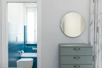 a bathroom with a white toilet and a mirror at Nuovo appartamento ben collegato con il centro in Rome