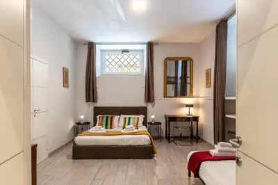 a bedroom with a bed and a window and a table at 3 comodi posti letto vicino Castel Sant'Angelo in Rome