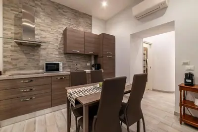 a kitchen and dining room with a table and chairs at 3 comodi posti letto vicino Castel Sant'Angelo in Rome