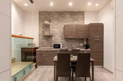 a kitchen with a table and chairs in a room at 3 comodi posti letto vicino Castel Sant'Angelo in Rome