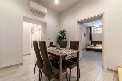 a dining room with a table and chairs at 3 comodi posti letto vicino Castel Sant'Angelo in Rome