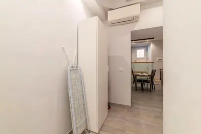 a room with a white refrigerator and a table at 3 comodi posti letto vicino Castel Sant'Angelo in Rome