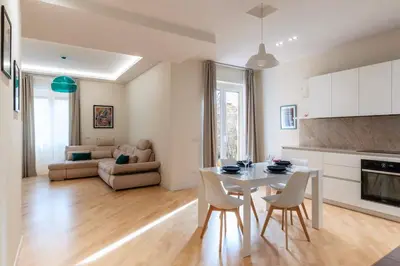 a kitchen and living room with a table and chairs at Appartamento moderno a 5 minuti dal Vaticano in Rome