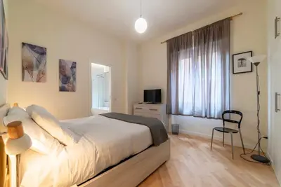 a bedroom with a large bed and a window at Appartamento moderno a 5 minuti dal Vaticano in Rome