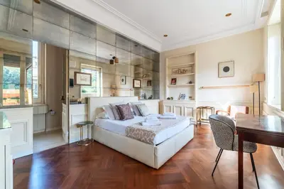 a bedroom with a bed and a table and a desk at Delizioso loft con terrazzo panoramico a Flaminio in Rome