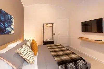 a bedroom with a bed and a flat screen tv at Stazione Termini - primo piano con ascensore in Rome