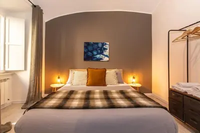 a bedroom with a large bed with two lamps at Stazione Termini - primo piano con ascensore in Rome