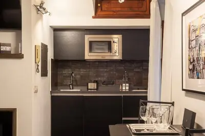 a kitchen with a sink and a microwave at Loft a due passi dal Pantheon in Rome