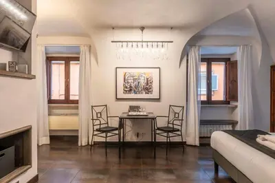 a living room with a dining room table and chairs at Loft a due passi dal Pantheon in Rome