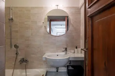 a bathroom with a sink and a mirror and a tub at Loft a due passi dal Pantheon in Rome