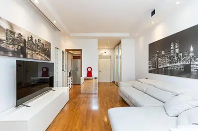 a living room with white couches and a tv at Quieto alloggio vicino stazione e metropolitana in Rome