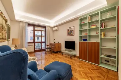 a living room with a blue couch and a television at Appartamento ben collegato con aeroporto e centro in Rome