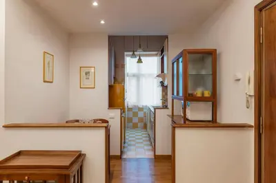 a living room with a hallway with a stairway at Appartamento ben collegato con aeroporto e centro in Rome