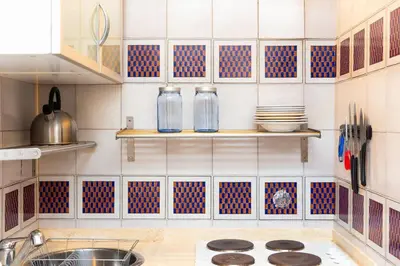 a kitchen with blue and white tiles and a sink at Autentico appartamento vicino al Pantheon in Rome