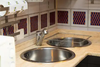 a kitchen sink with a faucet on a counter at Autentico appartamento vicino al Pantheon in Rome