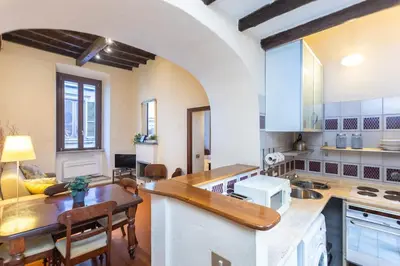 a large kitchen with a counter and a table at Autentico appartamento vicino al Pantheon in Rome