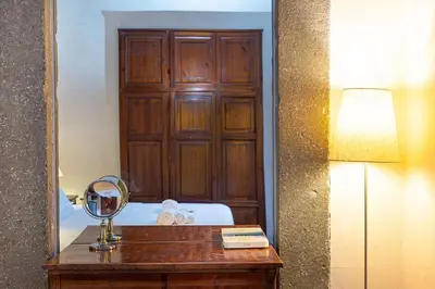 a mirror on a table with a bed in a room at Autentico appartamento vicino al Pantheon in Rome
