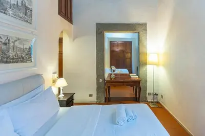 a bedroom with a bed and a desk and a mirror at Autentico appartamento vicino al Pantheon in Rome