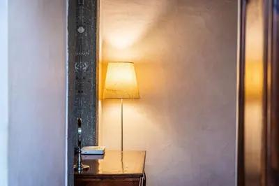 a lamp sitting on a table next to a wall at Autentico appartamento vicino al Pantheon in Rome