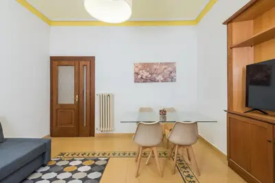 a living room with a table and two chairs at 4 comodi posti letto con giardino al Colosseo in Rome
