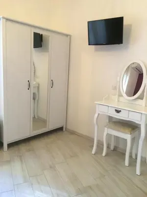 a bathroom with a vanity and a mirror and a sink at Appartamenti Romatour in Rome