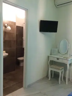 a bathroom with a sink and a toilet and a mirror at Appartamenti Romatour in Rome