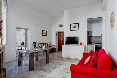 a living room with a red couch and a table at Domus Degli Angeli in Rome