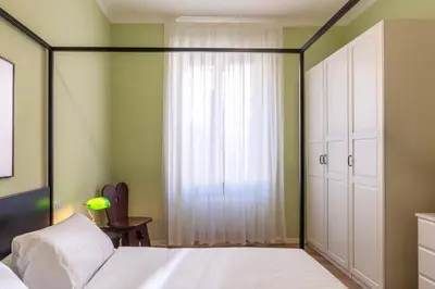 a bedroom with a white bed and a window at Elegante appartamento vicino il Vaticano in Rome