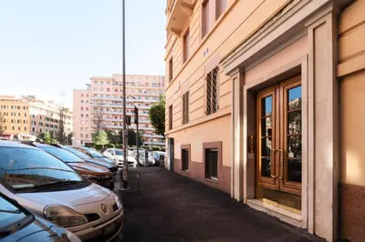 a row of parked cars parked next to a building at Elegante appartamento vicino il Vaticano in Rome