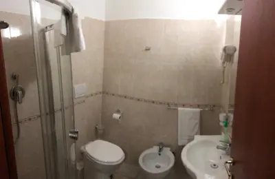 a small bathroom with a toilet and a sink at Sofia Holiday Home in Rome