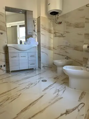 a bathroom with a sink and a toilet and a mirror at Sofia Holiday Home in Rome