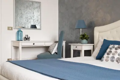 a bedroom with a bed and a desk and a chair at Apartment Termini in Rome