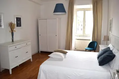 a bedroom with a white bed and a blue lamp at Apartment Termini in Rome